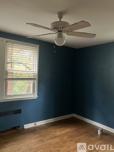 A room with blue walls and a ceiling fan.