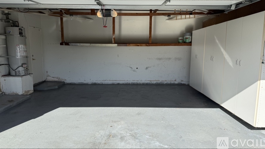A large empty room with a concrete floor and white walls.