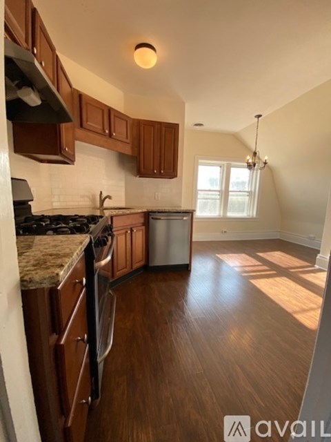 A kitchen with wooden cabinets and a granite countertop.