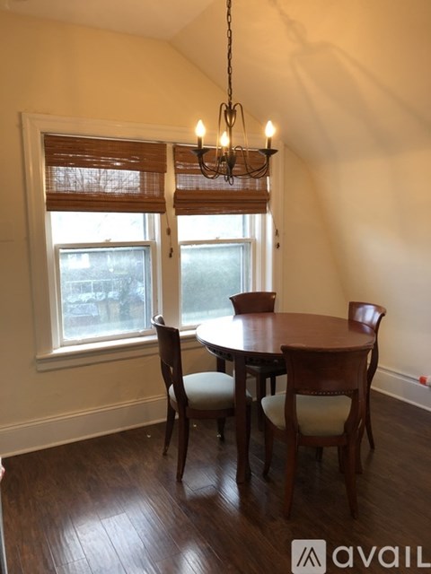 A dining room with a table and chairs.