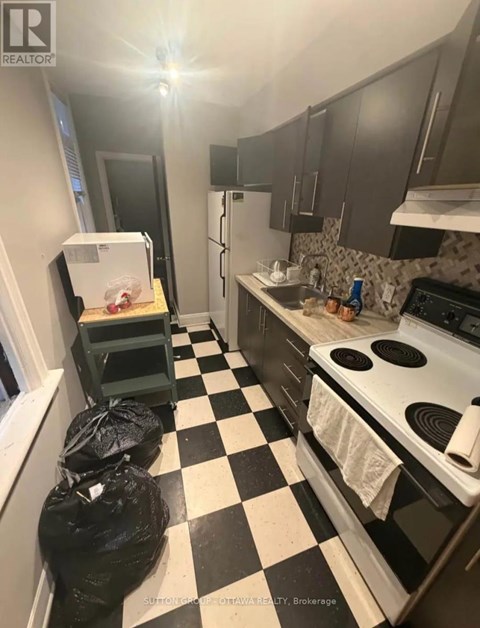 A black and white checkered floor in a kitchen.