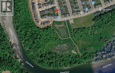 A satellite image shows a map of a neighborhood with a red marker indicating a specific location.
