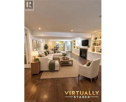 A living room with a couch, chair, and a rug.