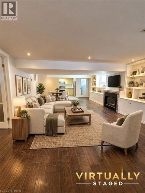 A living room with a couch, chair, and a rug.