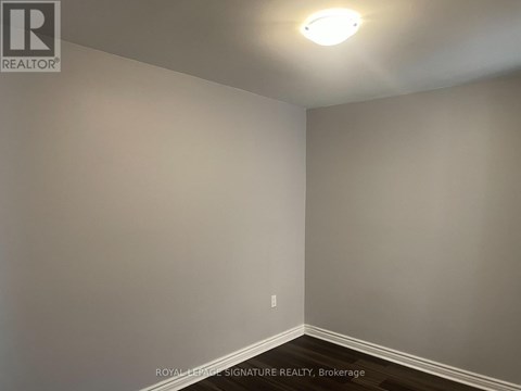 A room with a light on the ceiling and a wall socket on the wall.
