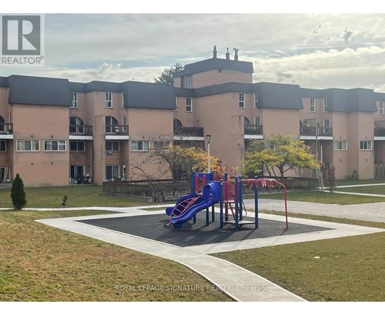 A playground with a blue slide in front of apartment buildings.