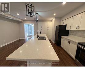 A kitchen with a white countertop and wooden floors.