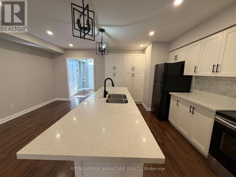 A kitchen with a white countertop and wooden floors.