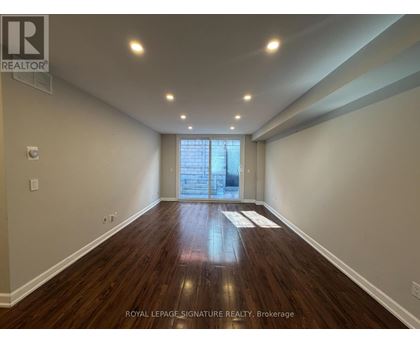 A room with wooden floors and a window in Brokerage.