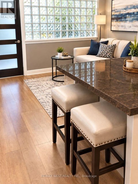 A kitchen with a table and two stools.