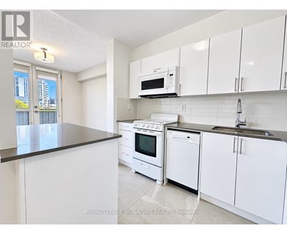 A kitchen with white cabinets and appliances is on the market.