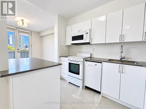 A kitchen with white cabinets and appliances is on the market.
