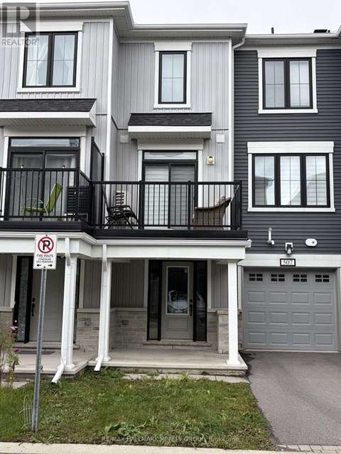 A two story house with a garage and a no parking sign in front.