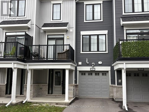 A building with the sign REMAX HALLMARK REALTY GROUP. BROKERAGE.