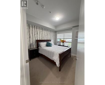 A bedroom with a bed, nightstand, and window with blinds.