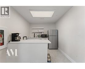 A kitchen with white cabinets and a white counter top.
