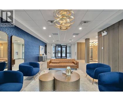 A modern office space with blue chairs and a wooden sofa.