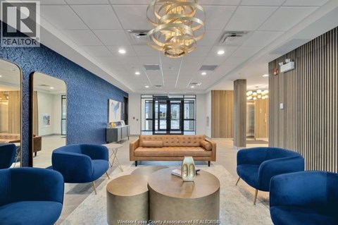 A modern office space with blue chairs and a wooden sofa.