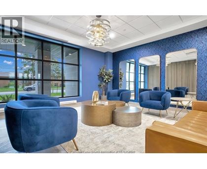 A living room with blue chairs and a wooden table.