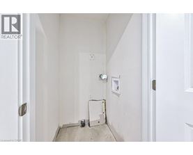 A white hallway with a door on the left and a door on the right.
