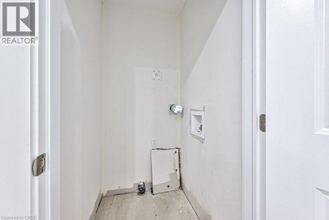 A white hallway with a door on the left and a door on the right.