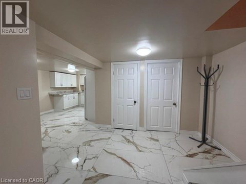 A room with marble flooring and white walls.