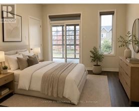 A bedroom with a large bed and a window overlooking a red building.