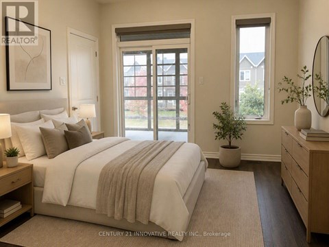 A bedroom with a large bed and a window overlooking a red building.