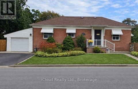 A house with a red brick exterior and a white garage door.