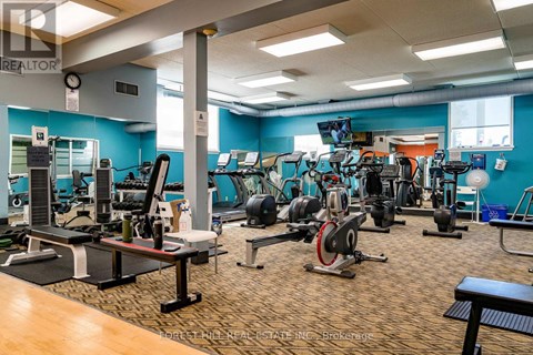 A gym with a variety of equipment including treadmills, weights, and exercise machines.