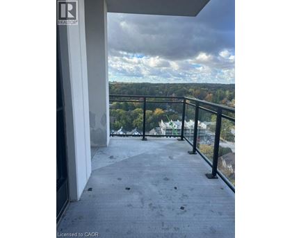 A balcony with a view of a cloudy sky and trees.