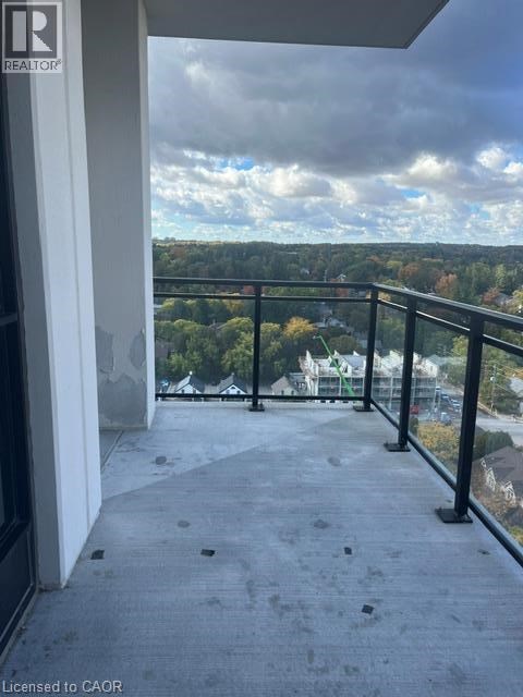 A balcony with a view of a cloudy sky and trees.