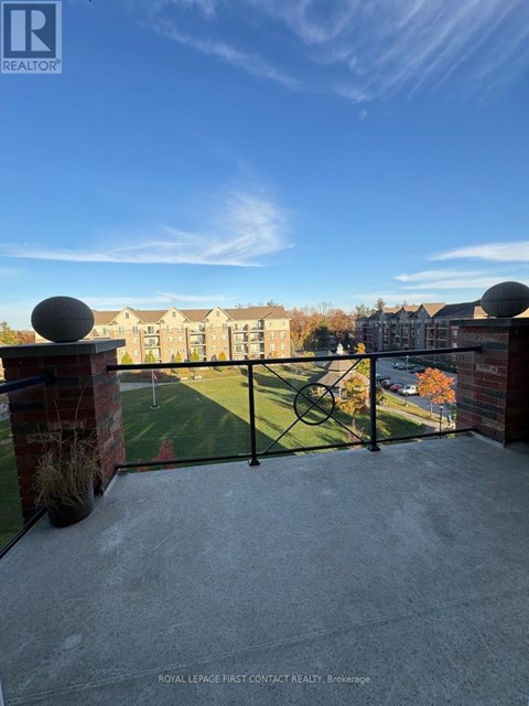 A balcony with a view of a building and a clear blue sky.