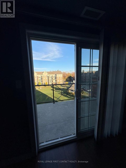 A view from inside a room looking out through a sliding glass door.