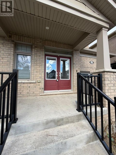 A house with a red door and a black railing.