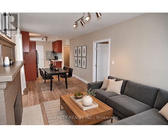 A living room with a grey couch and a coffee table in the middle.