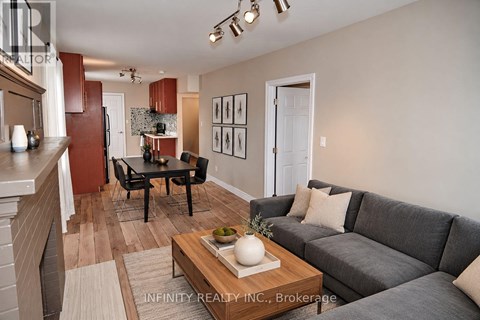 A living room with a grey couch and a coffee table in the middle.