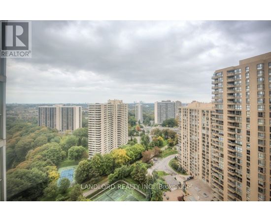 A view of a cityscape from a high-rise building with a pool in the foreground.