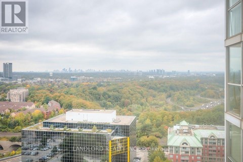 A view from a high-rise building looking out over a cityscape with a mix of residential and commercial buildings.