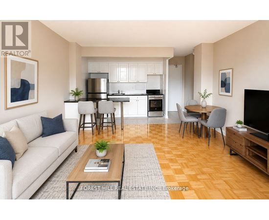 A well-lit, modern living room with a kitchen in the background.