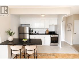 A modern kitchen with Forest Hill Real Estate Inc. logo on the bottom left.