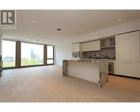 A spacious room with a marble island in the middle.