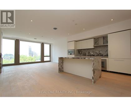 A spacious room with a marble island in the middle.