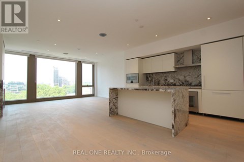 A spacious room with a marble island in the middle.
