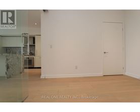 A white room with a door and a sign that says REALTOR.