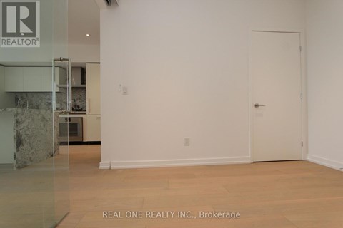 A white room with a door and a sign that says REALTOR.