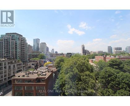 A cityscape with a Real One Realty building in the foreground.