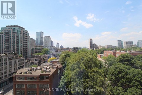 A cityscape with a Real One Realty building in the foreground.