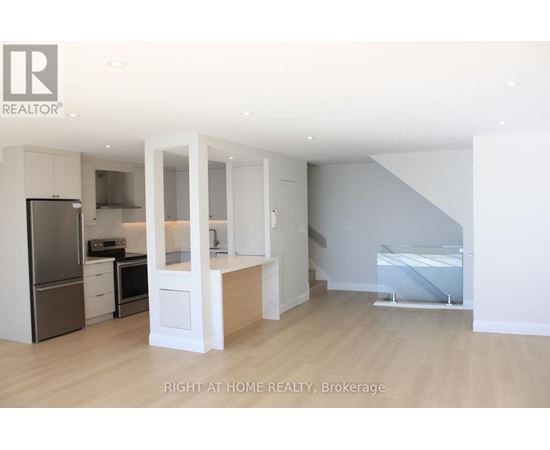 A modern kitchen with white cabinets and appliances.