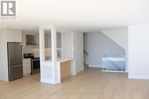 A modern kitchen with white cabinets and appliances.
